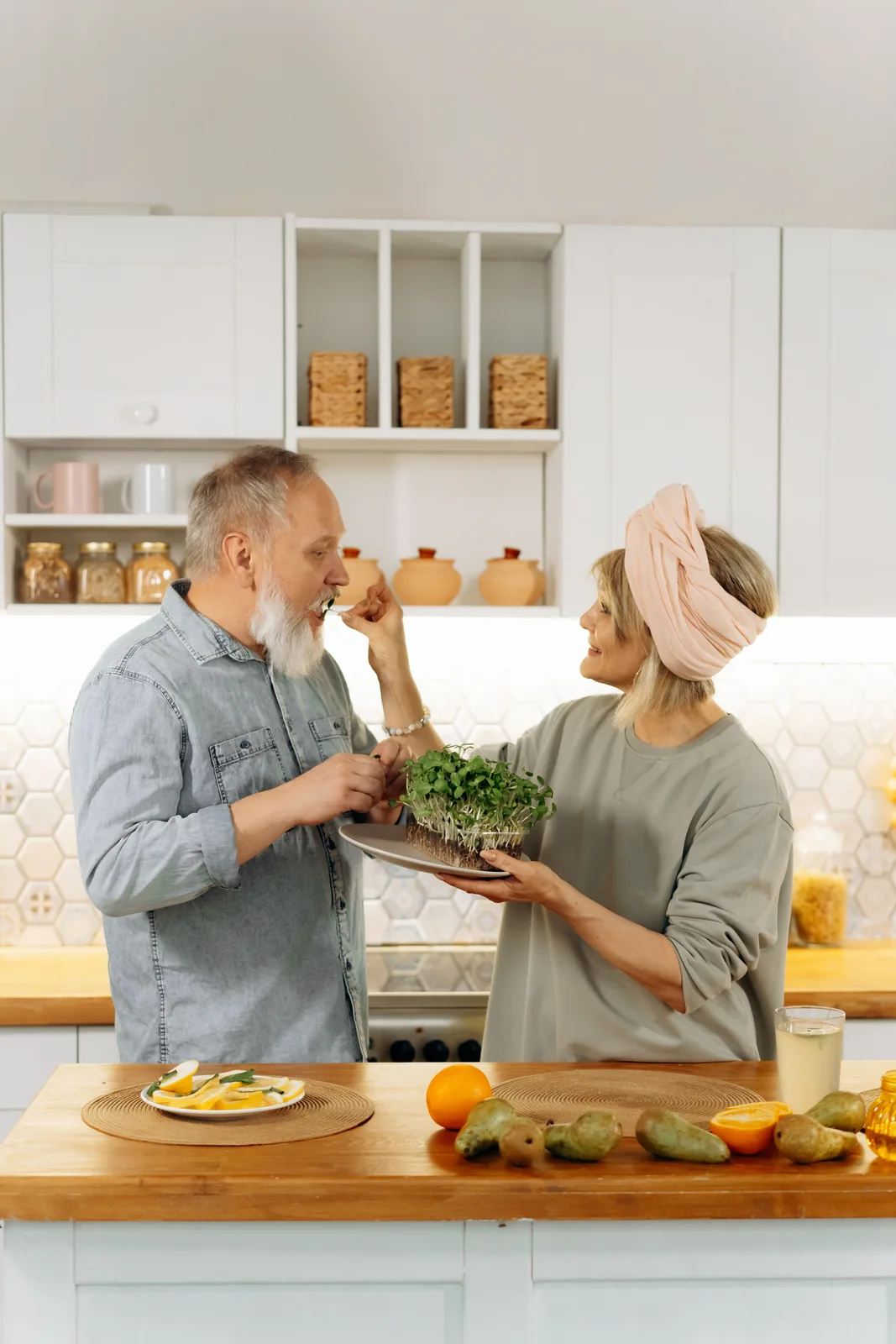 Older couple preparing nutritious food in a bright kitchen